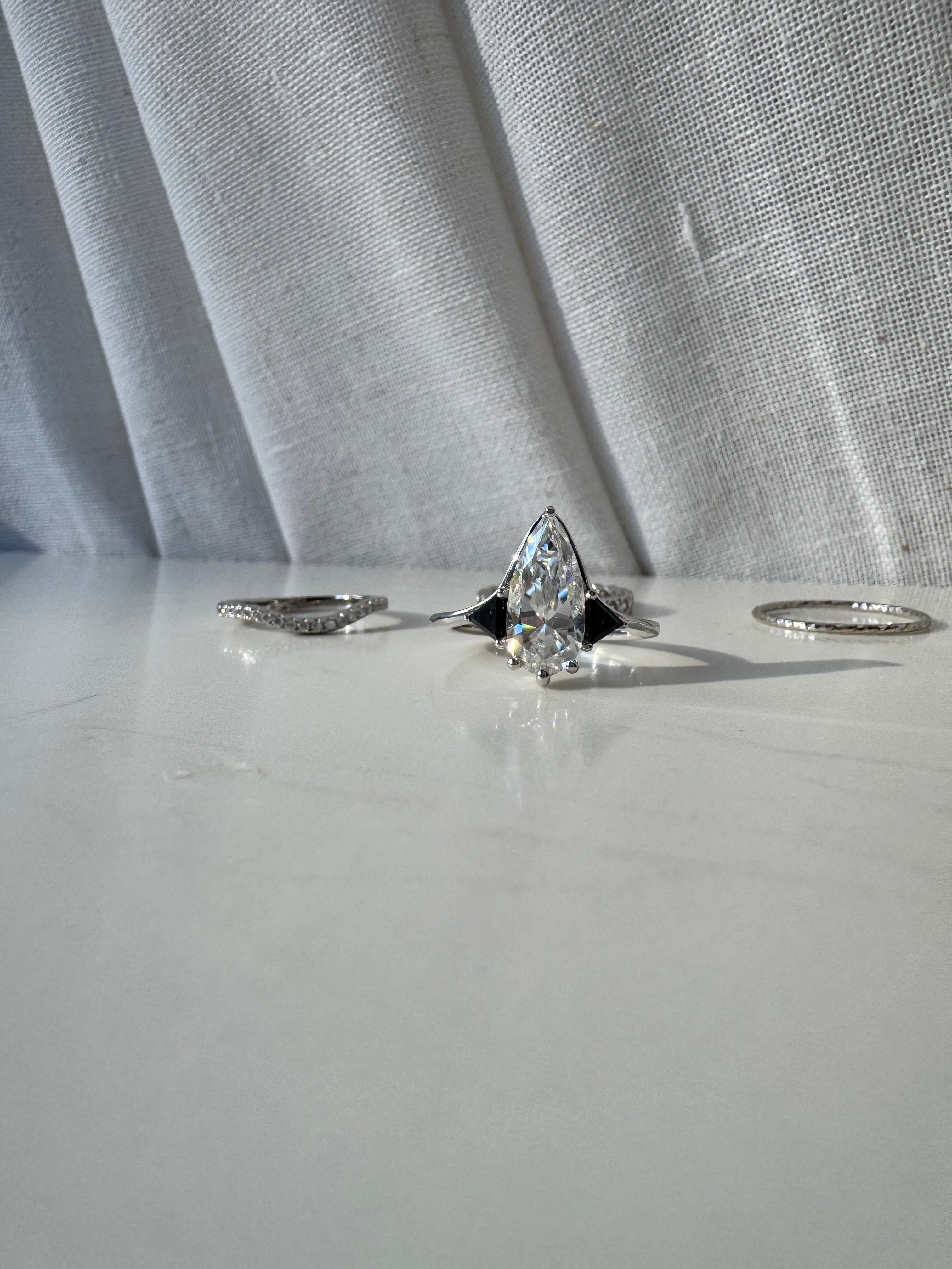 Moissanite Elongated Pear with Black Side Stones Engagement Ring