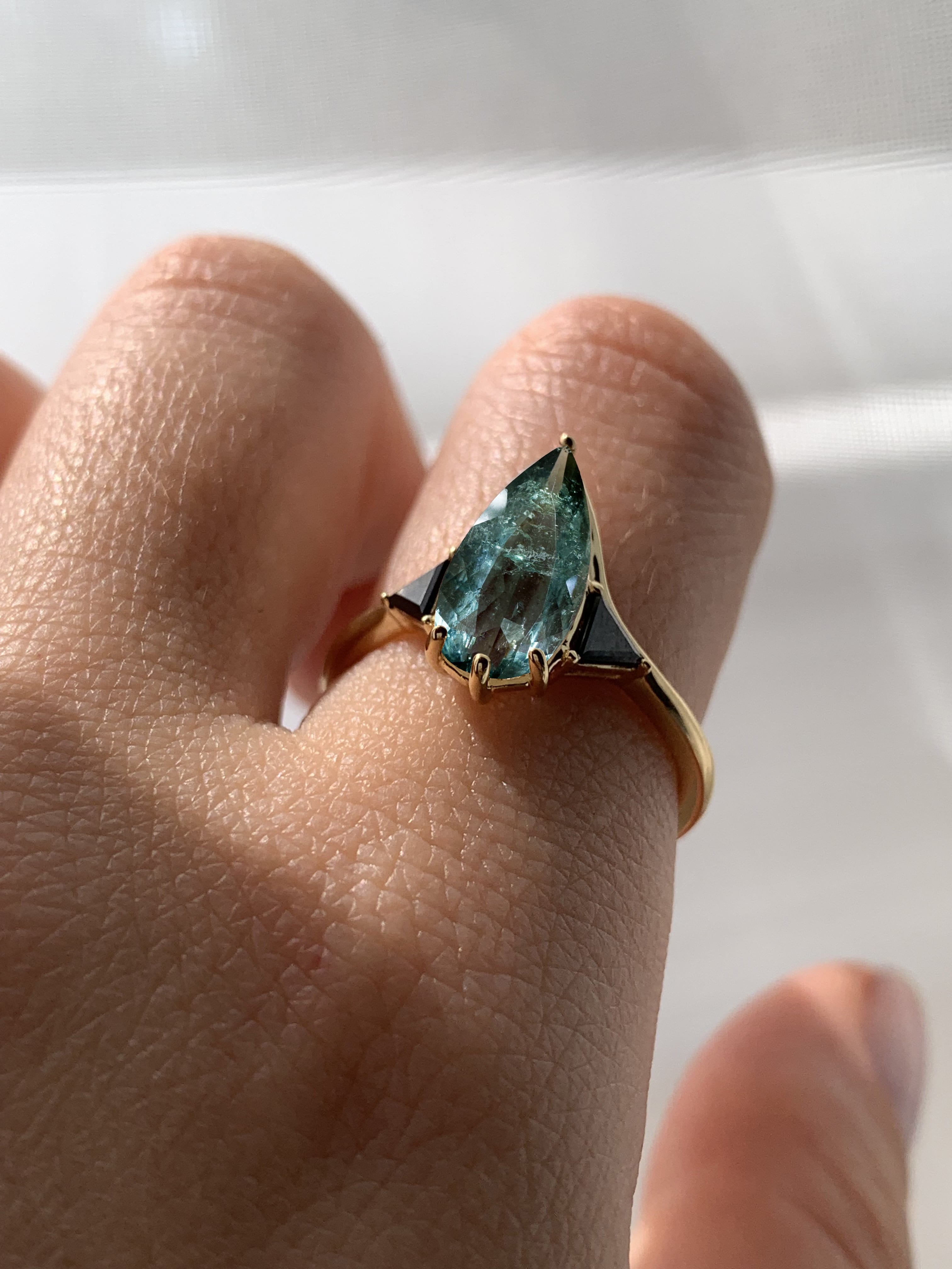 Blue Tourmaline Elongated Pear with Black Diamond Side Stones Engagement Ring