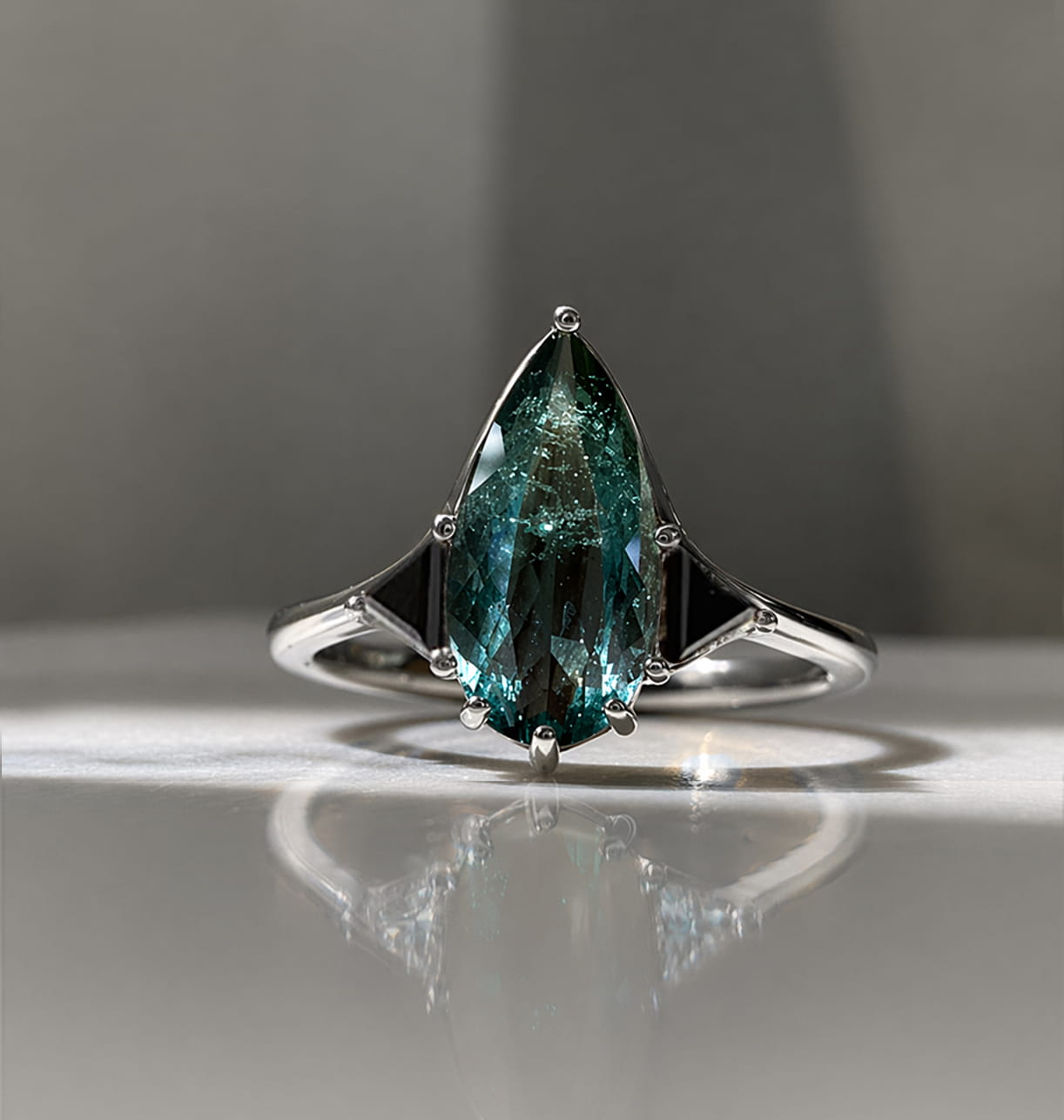 Blue Tourmaline Elongated Pear with Black Diamond Side Stones Engagement Ring