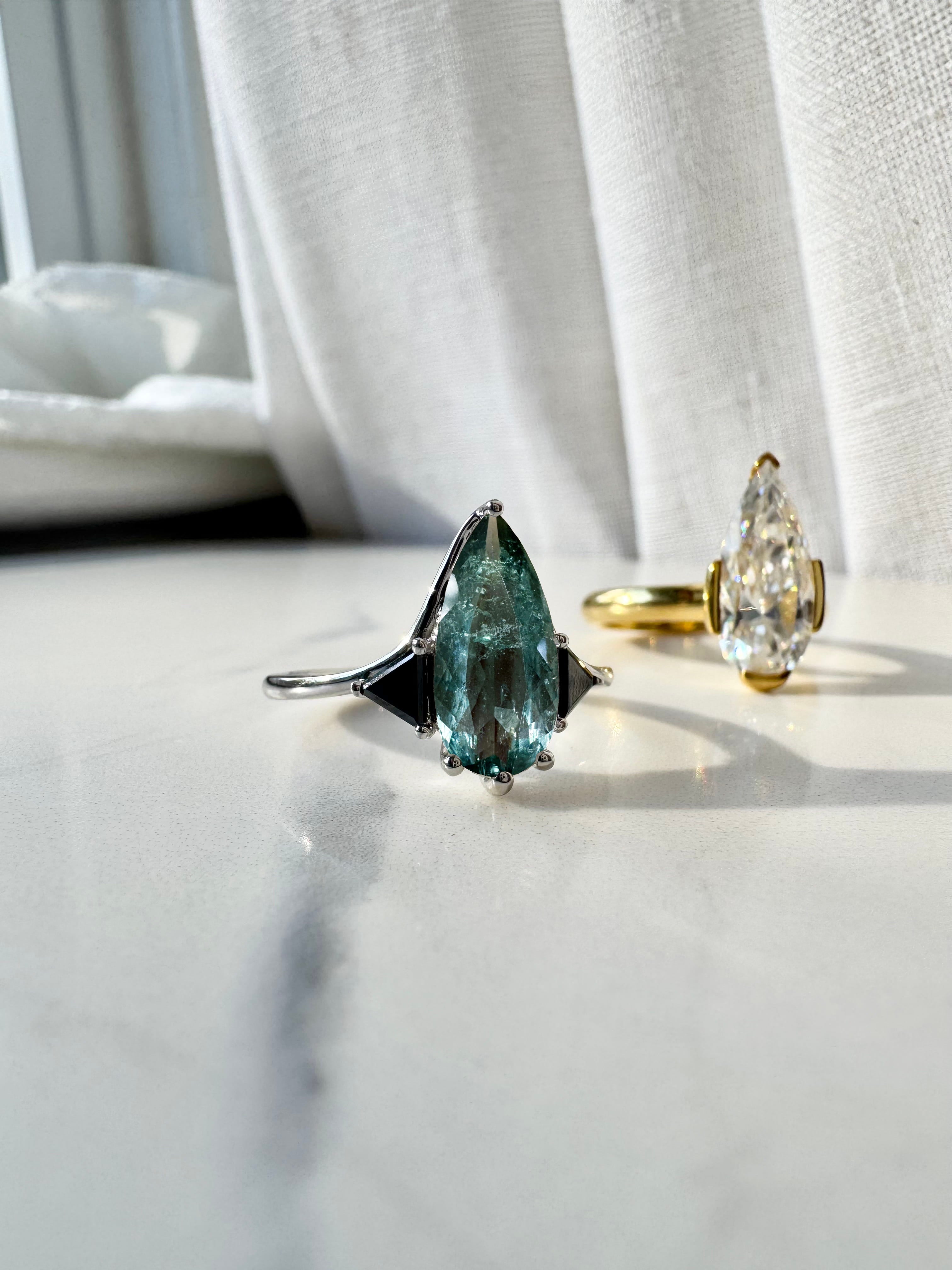 Blue Tourmaline Elongated Pear with Black Diamond Side Stones Engagement Ring