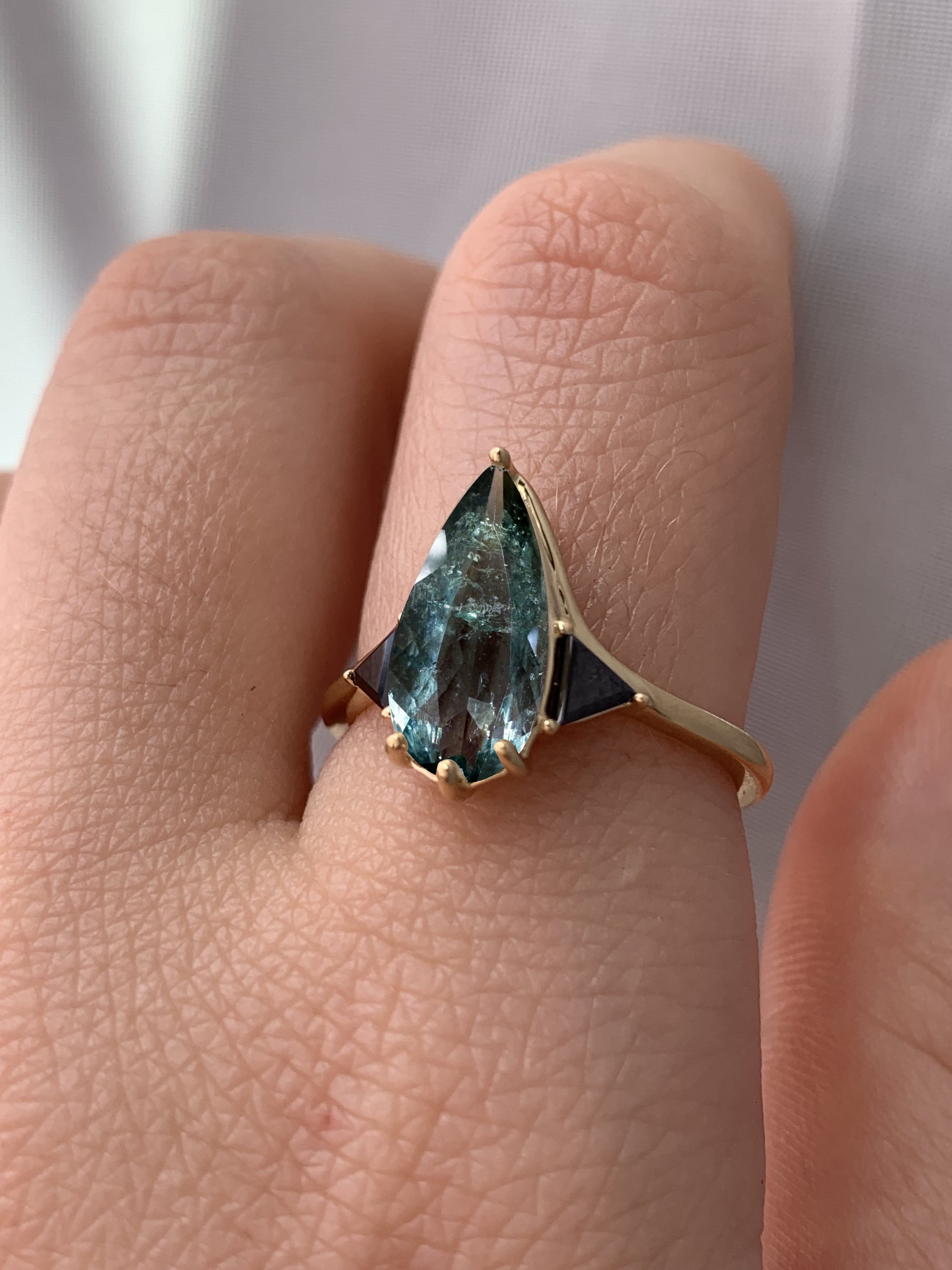 Blue Tourmaline Elongated Pear with Black Diamond Side Stones Engagement Ring