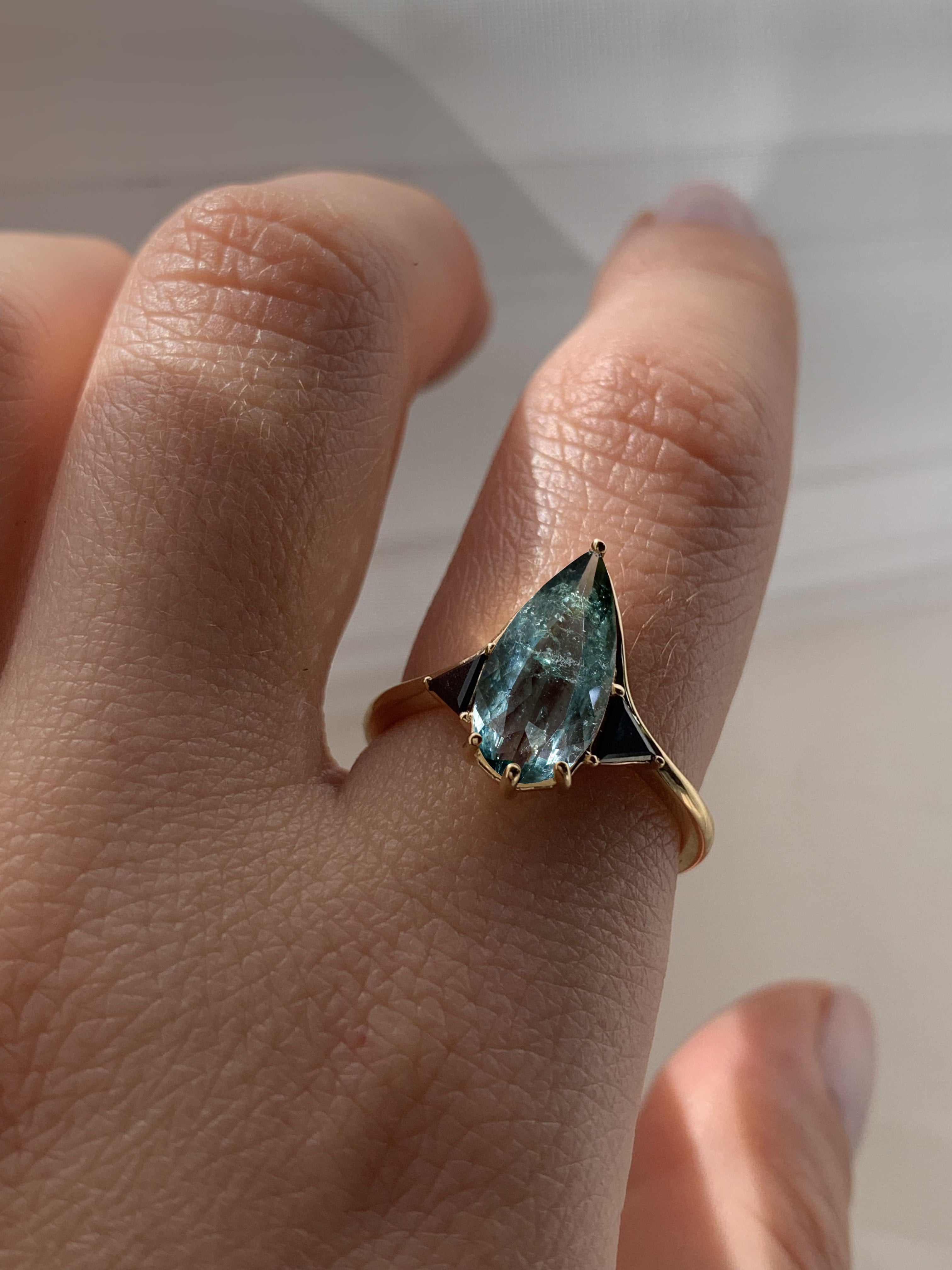 Blue Tourmaline Elongated Pear with Black Diamond Side Stones Engagement Ring